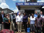 Peter Götz and the Chief Executive Officer of the Water Services Trust Fund, Eng. Jaqueline Musyoki (center), together with representatives of KfW, GIZ and African partners at a water supply kiosk in Mathare Village, Nairobi.